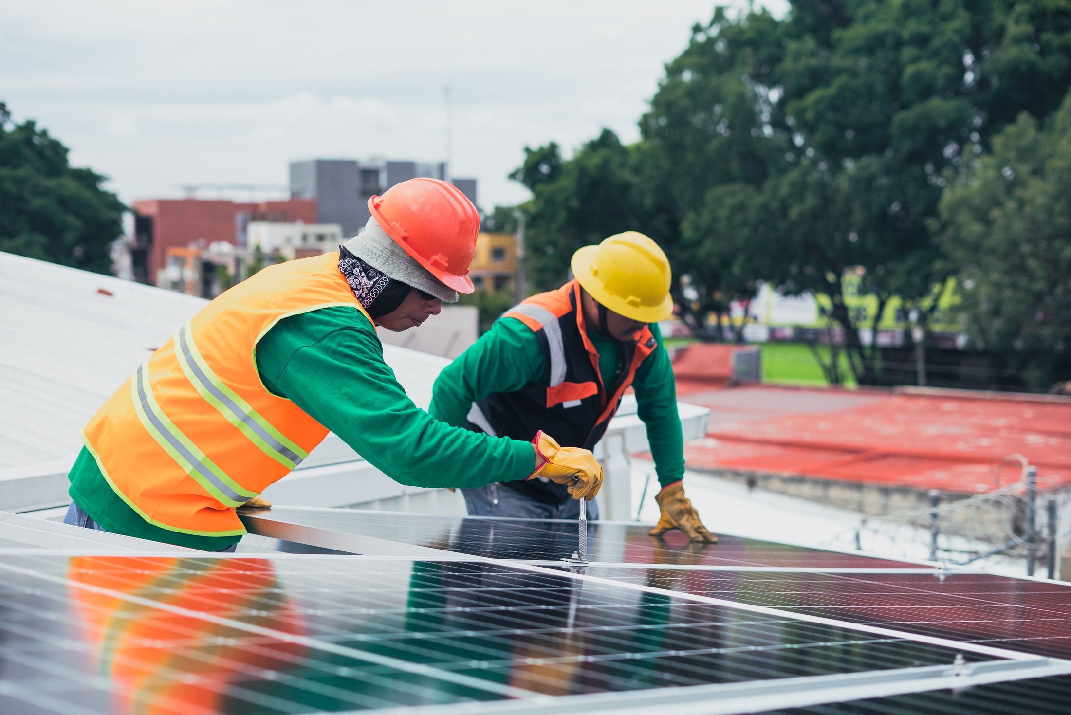 Crew installing modules on an industrial rooftop