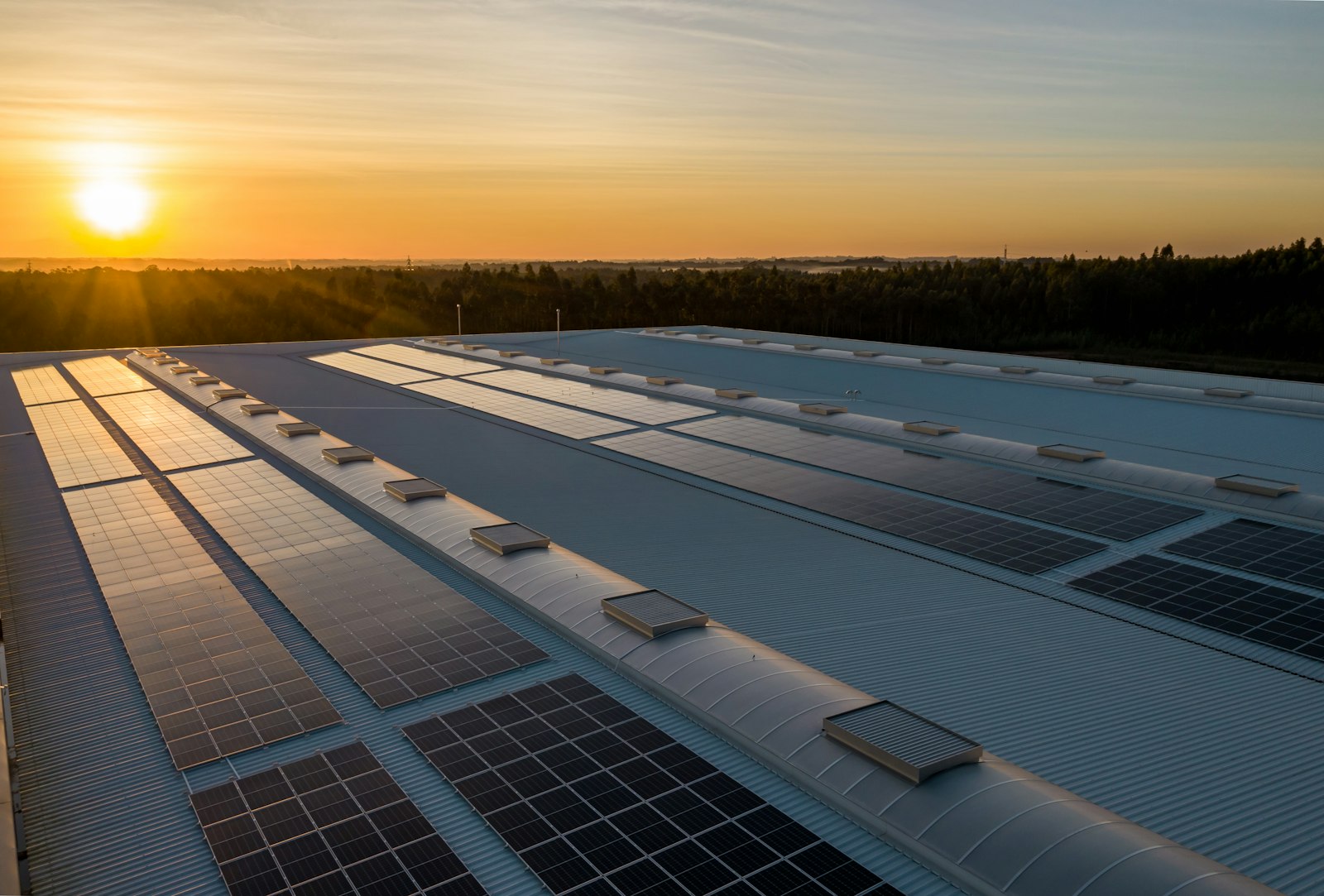 Rooftop solar plant on an industrial building at sunset